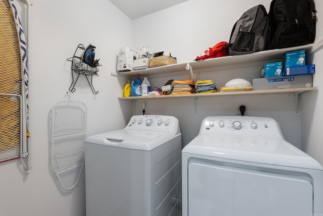 clothes washing area with washing machine and clothes dryer