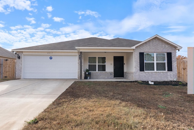 ranch-style home with a front yard, a garage, and covered porch