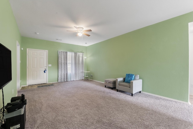 sitting room with carpet flooring and ceiling fan