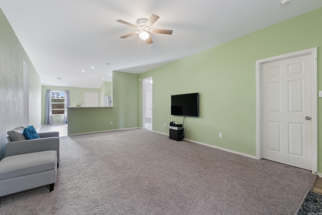 carpeted living room featuring ceiling fan