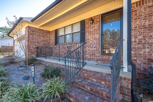 property entrance with a porch and a garage