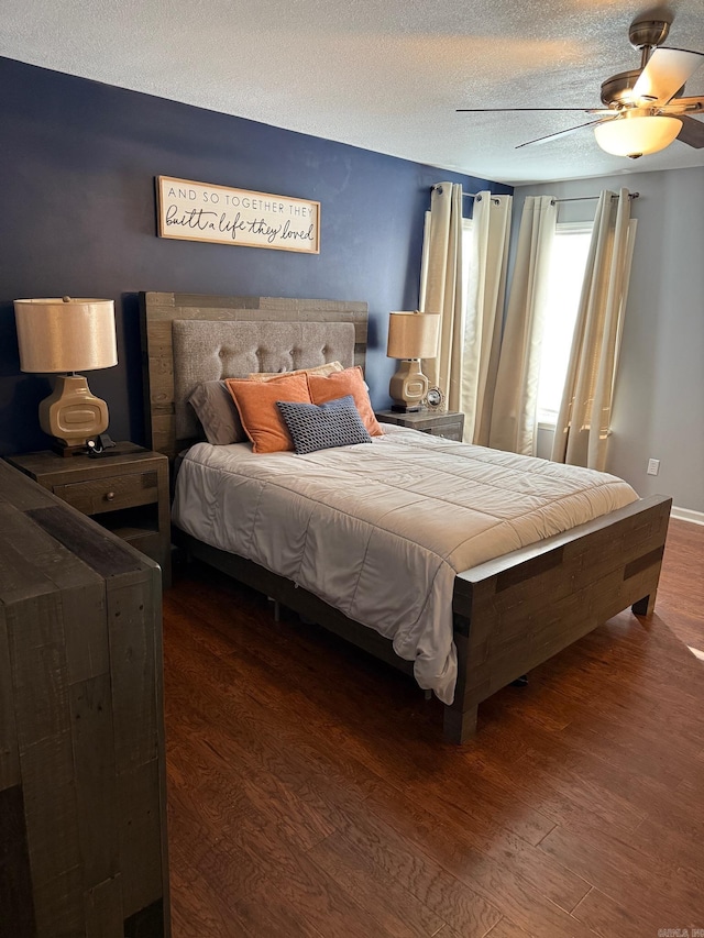 bedroom with hardwood / wood-style floors, ceiling fan, and a textured ceiling