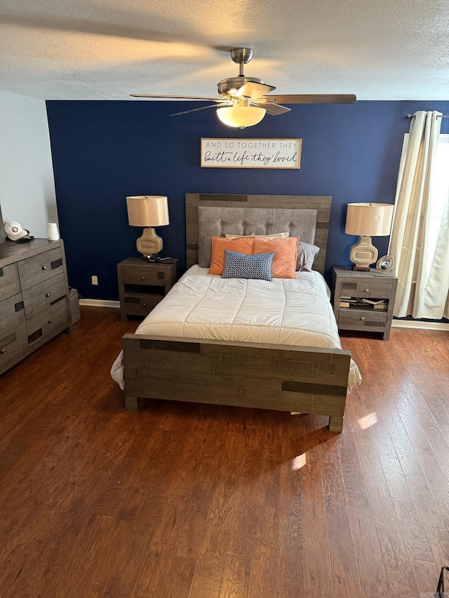 bedroom featuring hardwood / wood-style flooring, ceiling fan, and a textured ceiling