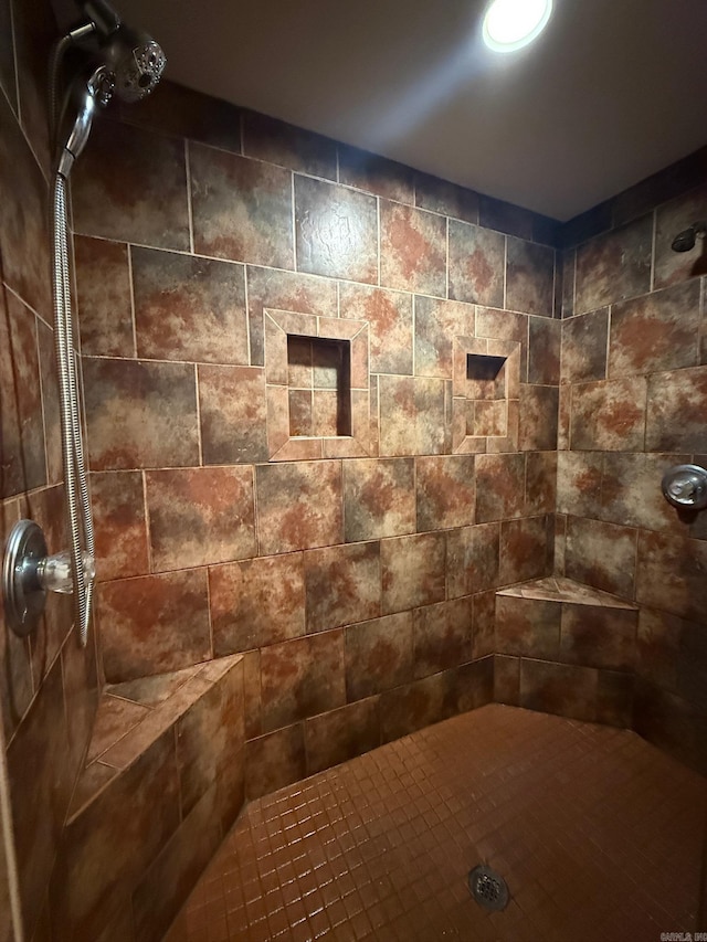 bathroom with a tile shower