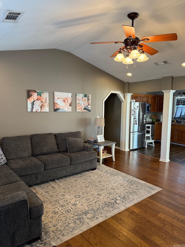 living room with ceiling fan, dark hardwood / wood-style flooring, sink, and vaulted ceiling