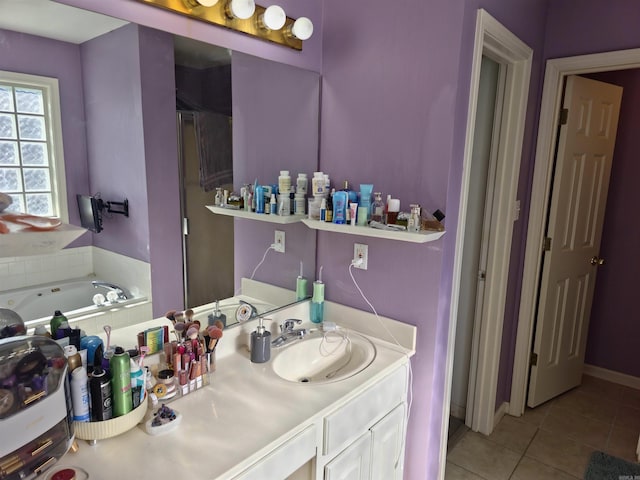 bathroom featuring vanity, tile patterned floors, and a bathtub