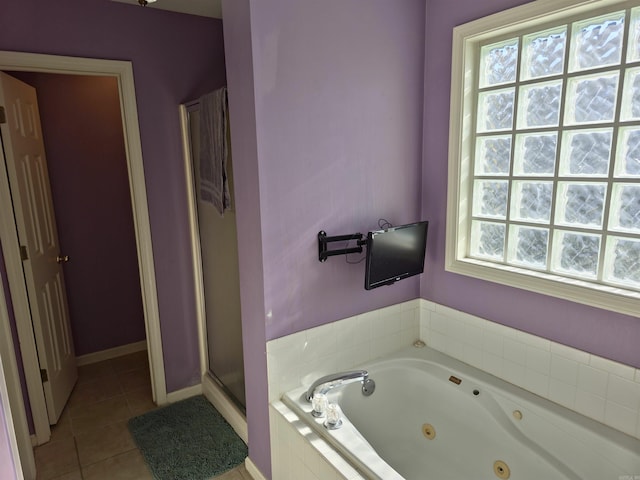 bathroom featuring tile patterned floors and independent shower and bath