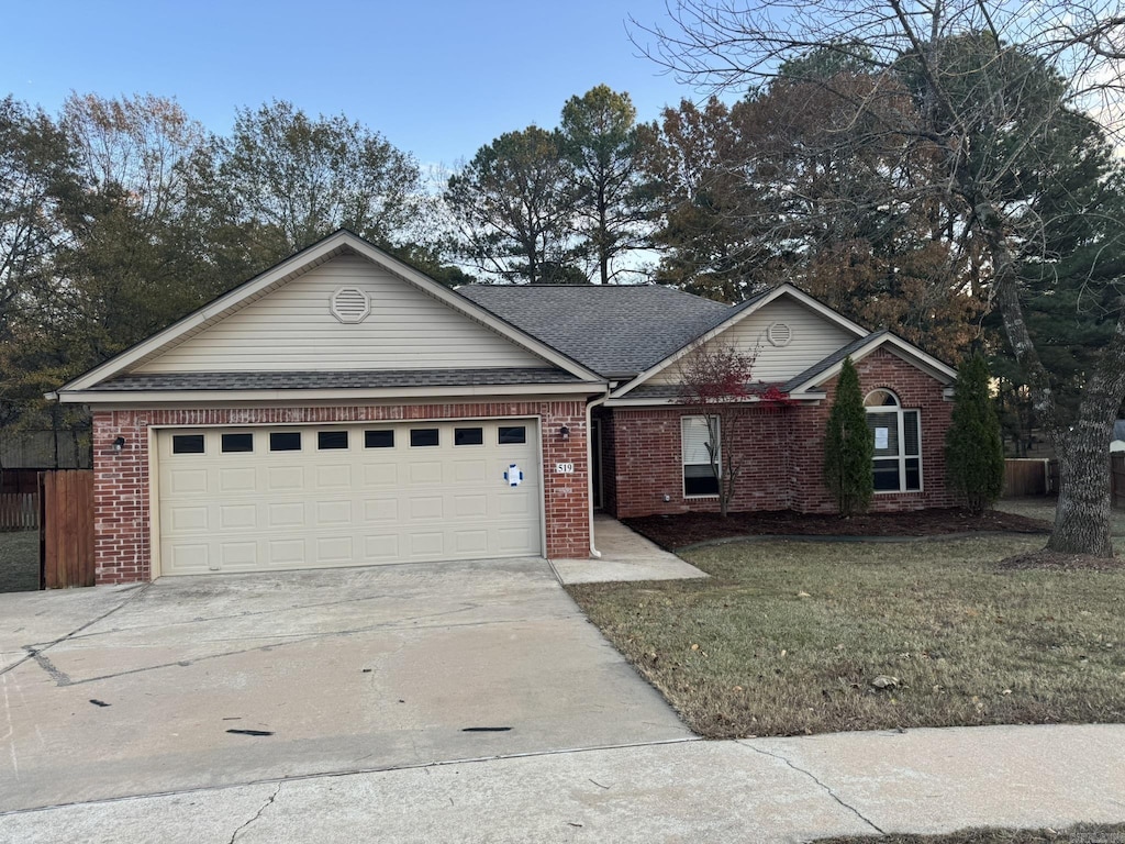 ranch-style house featuring a front lawn and a garage