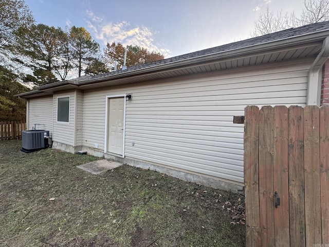 view of side of home with central AC