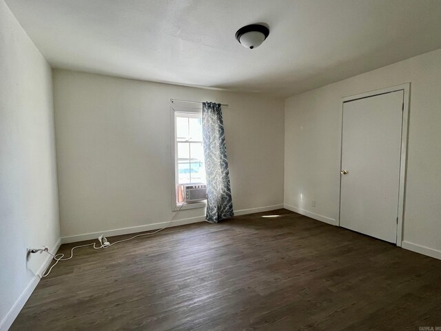 unfurnished room with dark hardwood / wood-style flooring and cooling unit