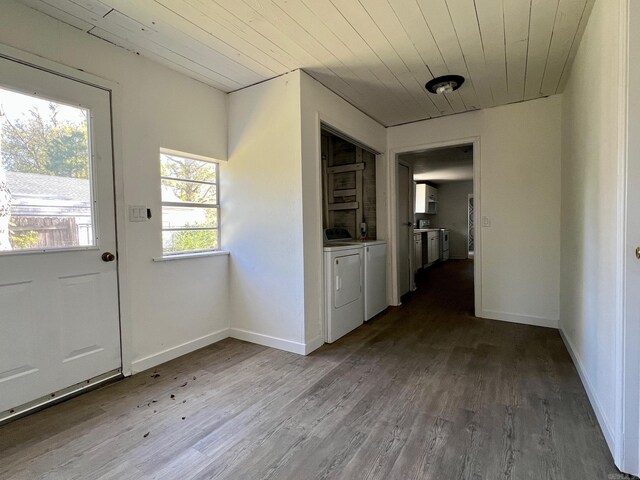 doorway featuring washer and dryer, wood-type flooring, and wood ceiling