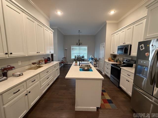 kitchen with a center island, dark hardwood / wood-style flooring, stainless steel appliances, and hanging light fixtures