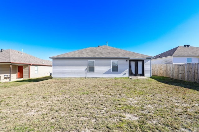 rear view of house with a lawn