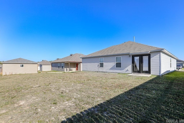 rear view of house featuring a yard