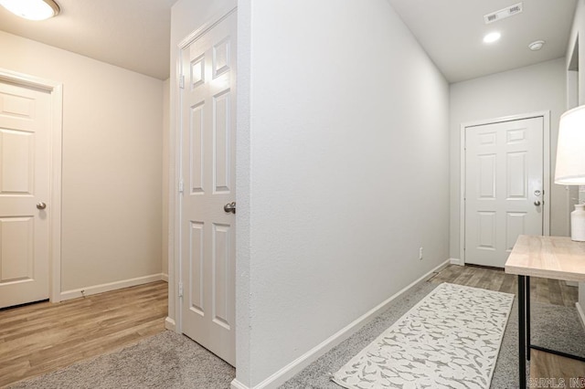 hall with hardwood / wood-style floors