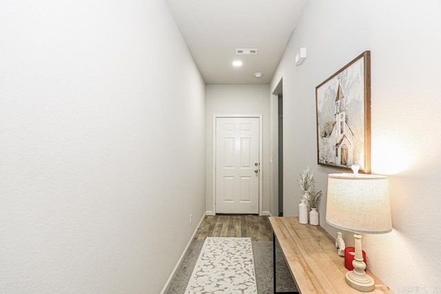 hallway with hardwood / wood-style floors