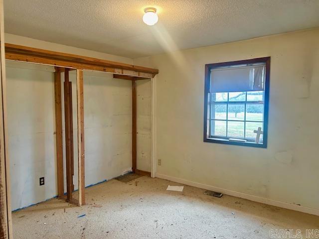 unfurnished bedroom with a textured ceiling