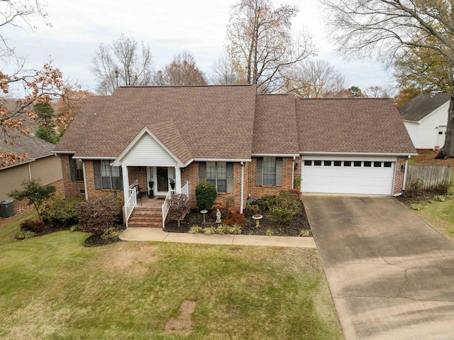 view of front of house with a front yard, a porch, and a garage