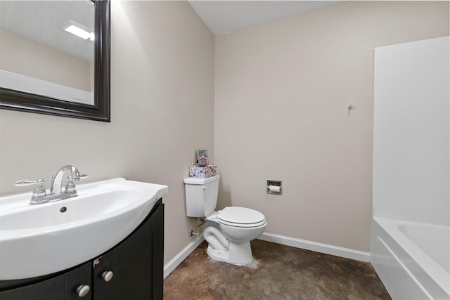 bathroom featuring vanity, toilet, and a tub