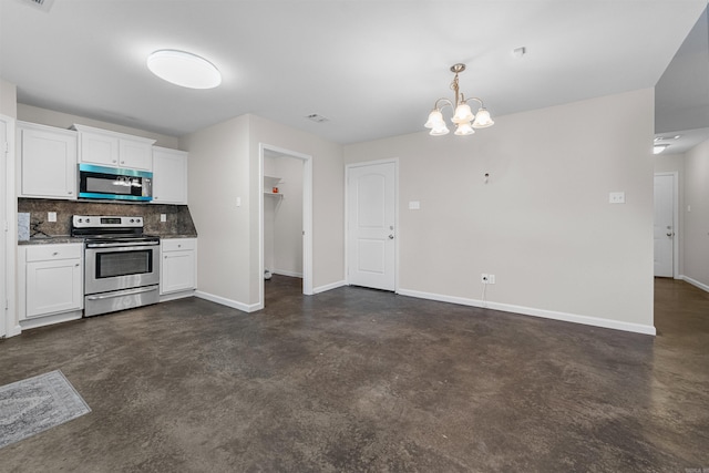 kitchen with white cabinets, decorative backsplash, stainless steel appliances, and an inviting chandelier