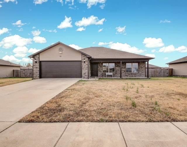 ranch-style house with a front yard and a garage