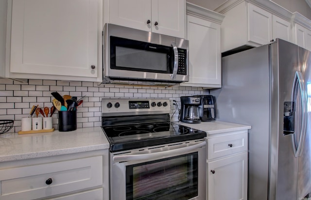 kitchen with backsplash, light stone countertops, white cabinetry, and stainless steel appliances