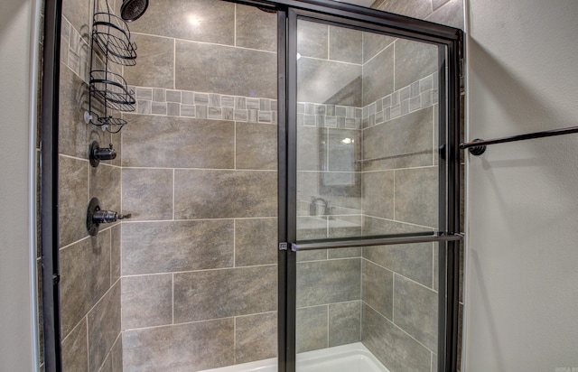 bathroom with a shower with shower door