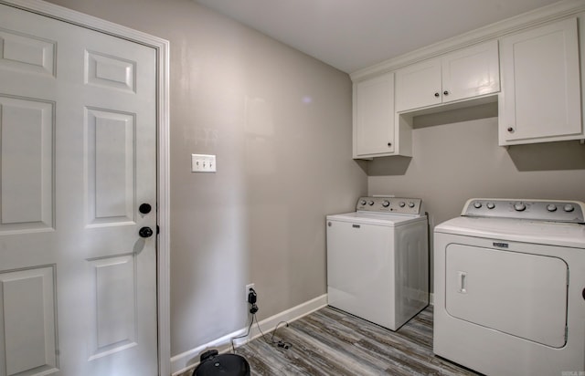 laundry area with washer and clothes dryer, cabinets, and light wood-type flooring