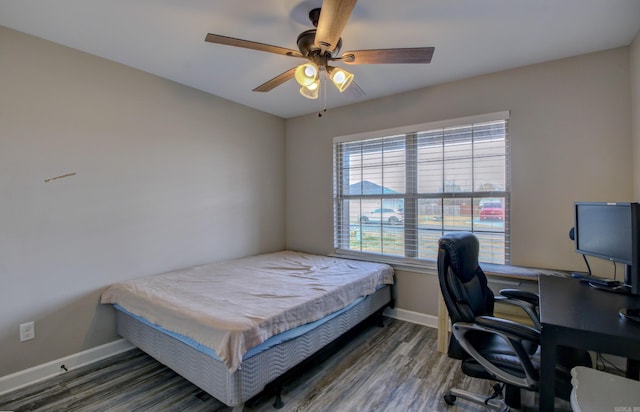 bedroom with ceiling fan and dark wood-type flooring