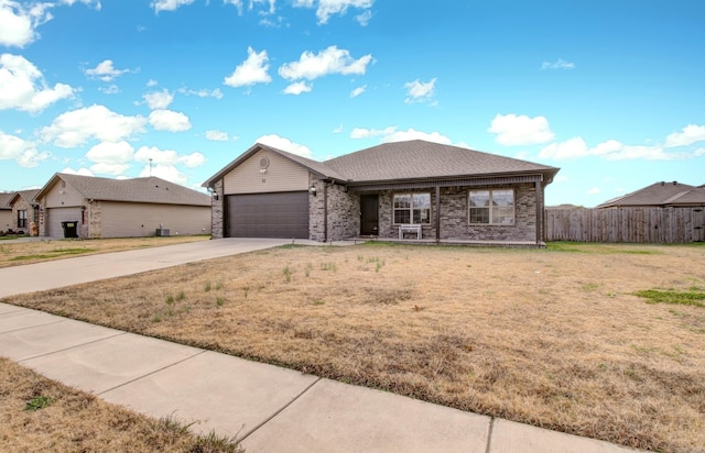 ranch-style house with a garage and a front yard