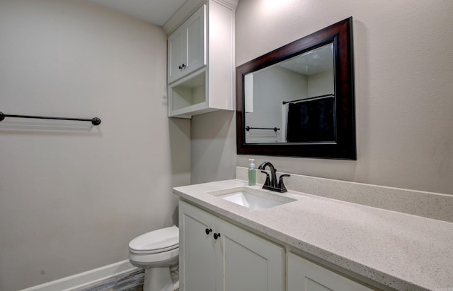 bathroom featuring vanity, wood-type flooring, and toilet