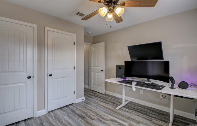 office space with light wood-type flooring and ceiling fan