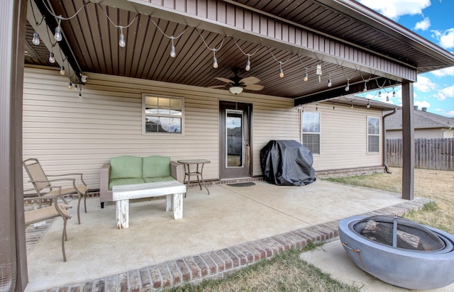 view of patio with a fire pit, ceiling fan, and a grill