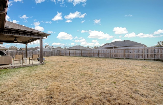 view of yard featuring ceiling fan and a patio area