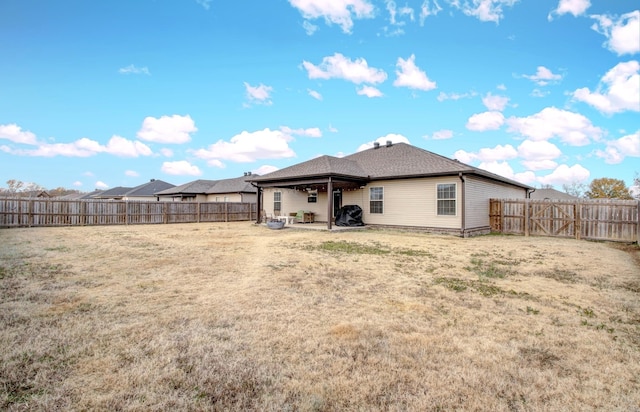 rear view of house featuring a lawn