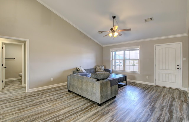 living room featuring hardwood / wood-style flooring, ceiling fan, crown molding, and vaulted ceiling