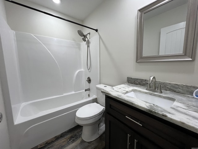 full bathroom with toilet, vanity, hardwood / wood-style flooring, and bathing tub / shower combination