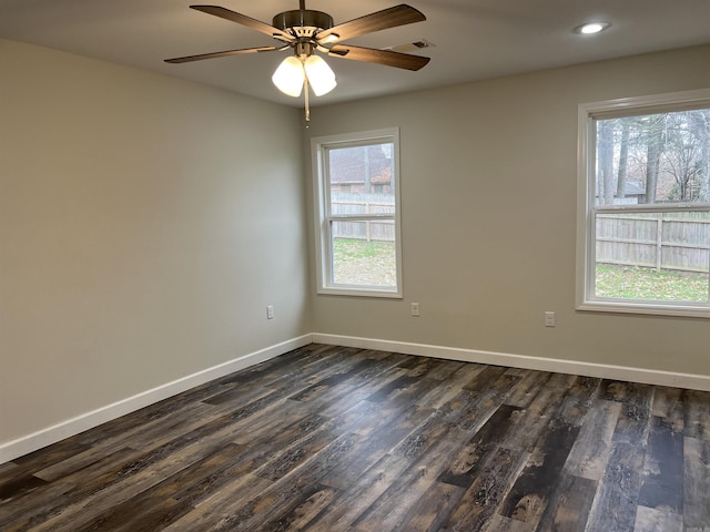 spare room with ceiling fan and dark wood-type flooring