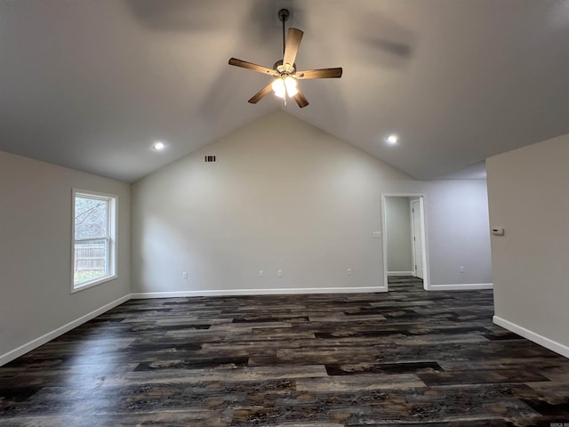 spare room with dark hardwood / wood-style floors, high vaulted ceiling, and ceiling fan