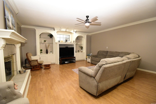 living room featuring a fireplace, light hardwood / wood-style floors, and crown molding