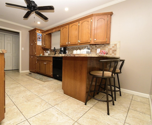 kitchen featuring dishwasher, ornamental molding, light tile patterned floors, tasteful backsplash, and a kitchen bar