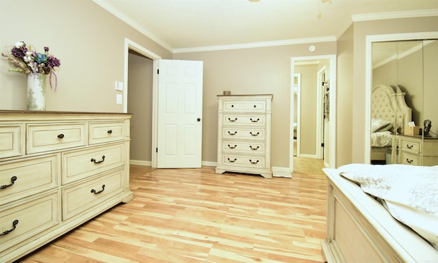 bedroom featuring ornamental molding, light hardwood / wood-style flooring, and a closet