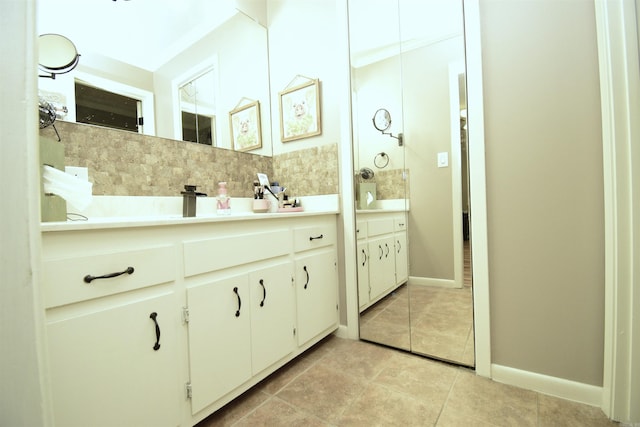 bathroom featuring tasteful backsplash, tile patterned flooring, and vanity