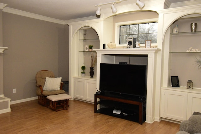 living area with light hardwood / wood-style floors and crown molding