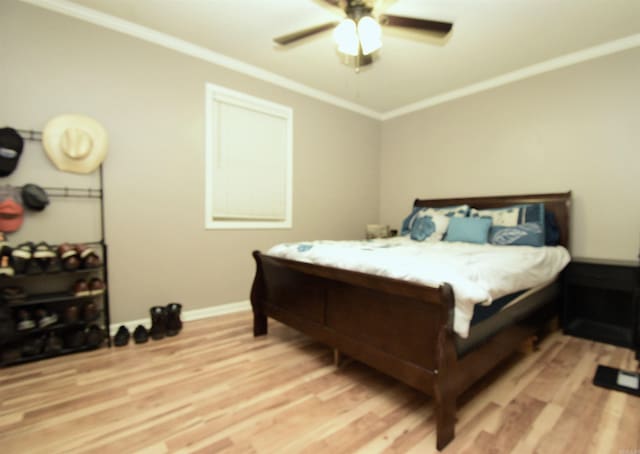 bedroom with ceiling fan, light hardwood / wood-style flooring, and crown molding