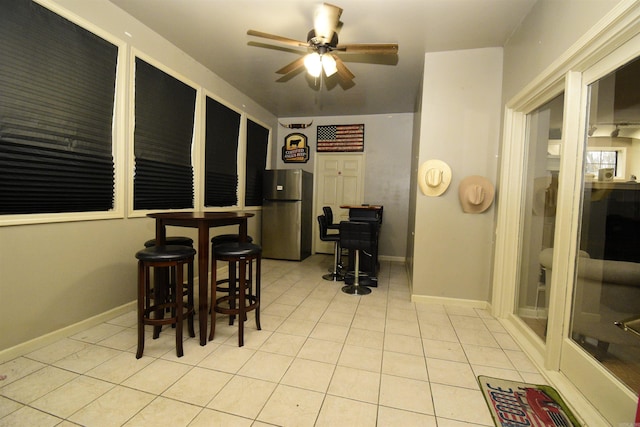 tiled dining area featuring ceiling fan