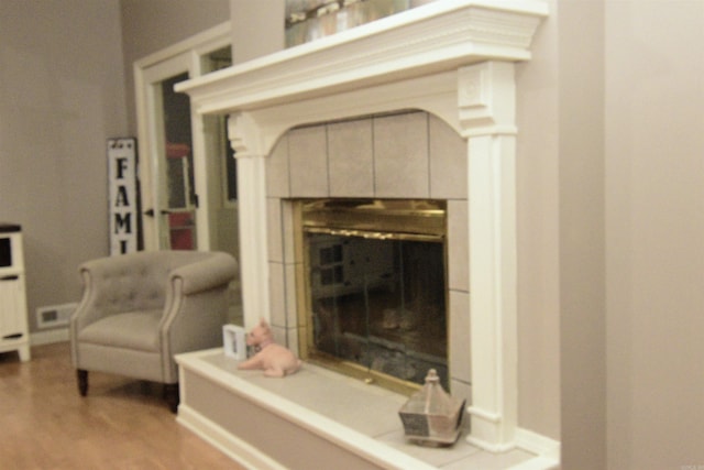 details with a tile fireplace