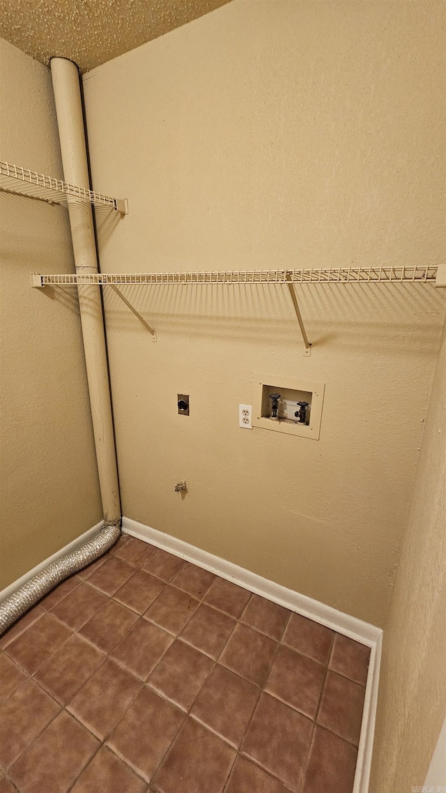 laundry room featuring washer hookup, dark tile patterned floors, and electric dryer hookup