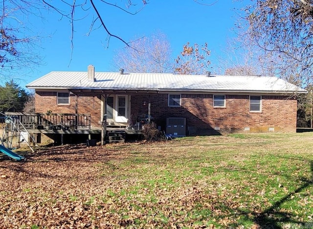 rear view of house with cooling unit, a deck, and a yard