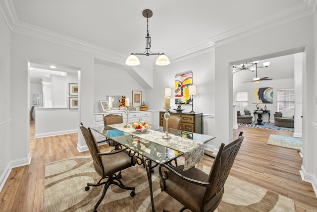 dining room featuring light hardwood / wood-style flooring, ceiling fan, and ornamental molding